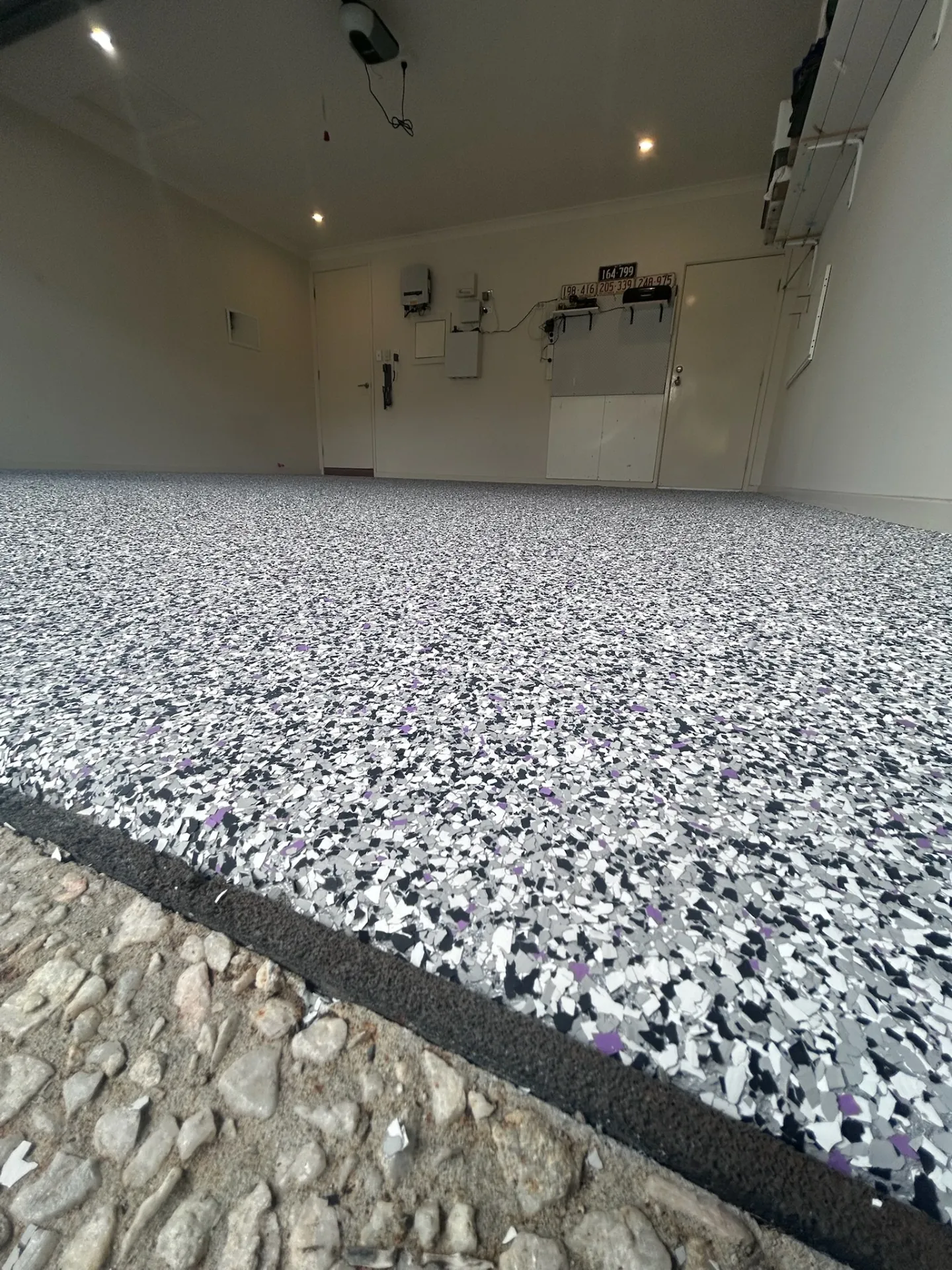 Premium epoxy flooring in a modern Melbourne garage